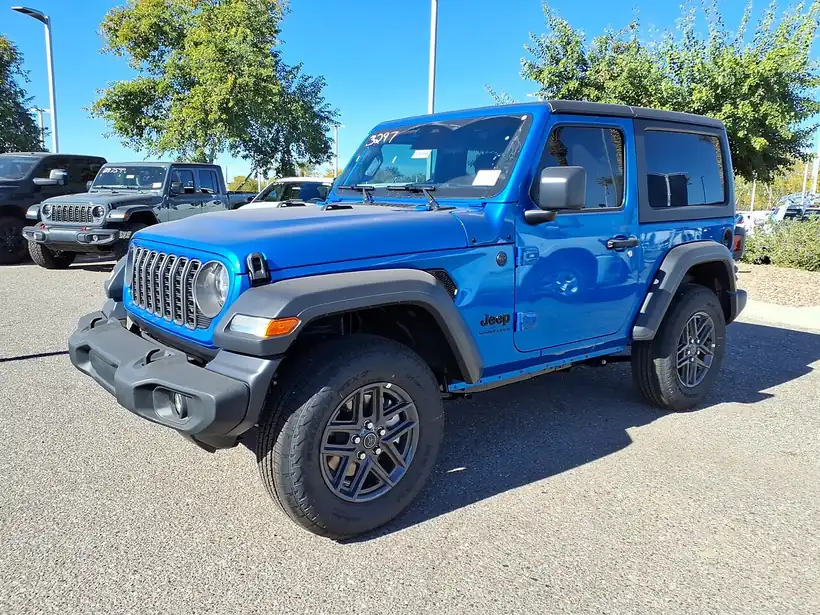 2026 Jeep Wrangler Sport S (JL) in Hydro Blue, front three-quarter view showing black fender flares and machined alloy wheels