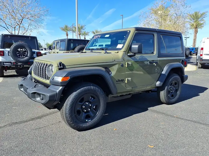 2026 Jeep Wrangler Sport (JL) in Sarge Green, front three-quarter view showing matte-black fender flares and 17-inch wheels